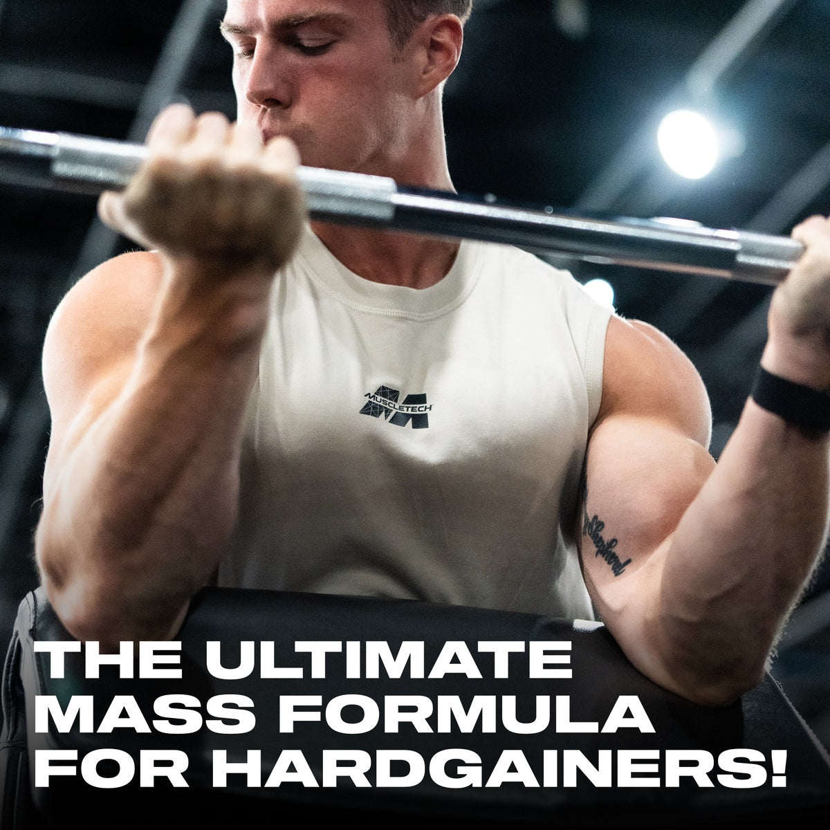 Man curling barbell wearing a MuscleTech shirt with headline “The ultimate mass formula for hardgainers,” highlighting the product's muscle-building potential.